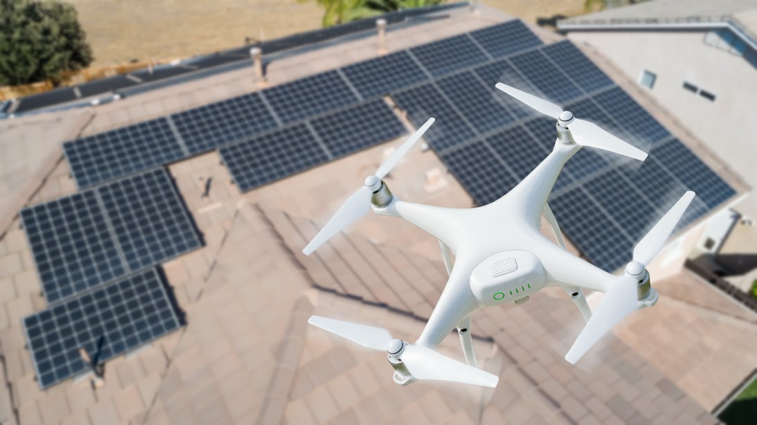 UAV Drone Inspecting Solar Panels on Large House